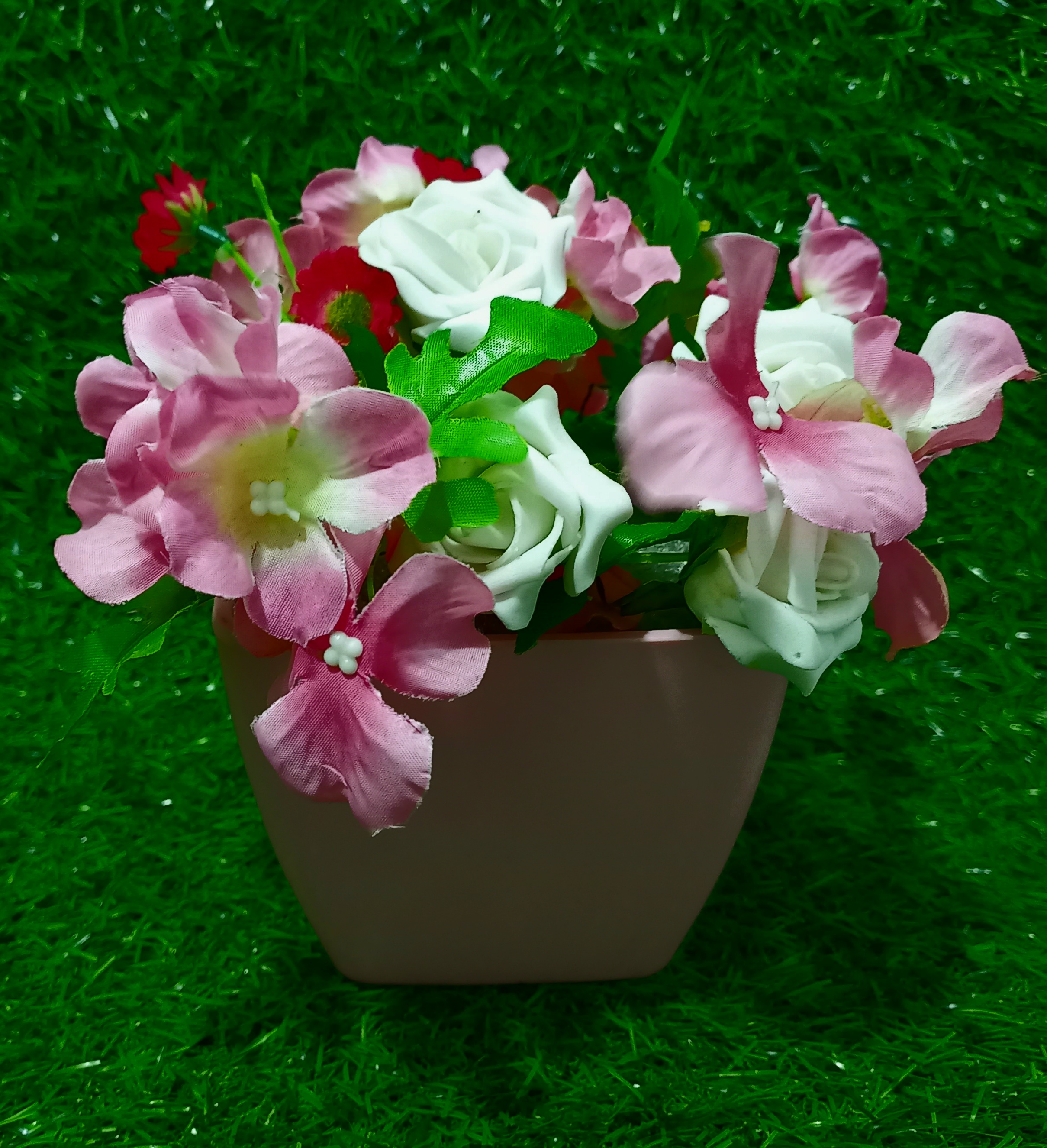 pink flower with pink plastic vase for tea cup
